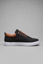 Side profile of black woven trainer with tan leather heel tab and white cupsole