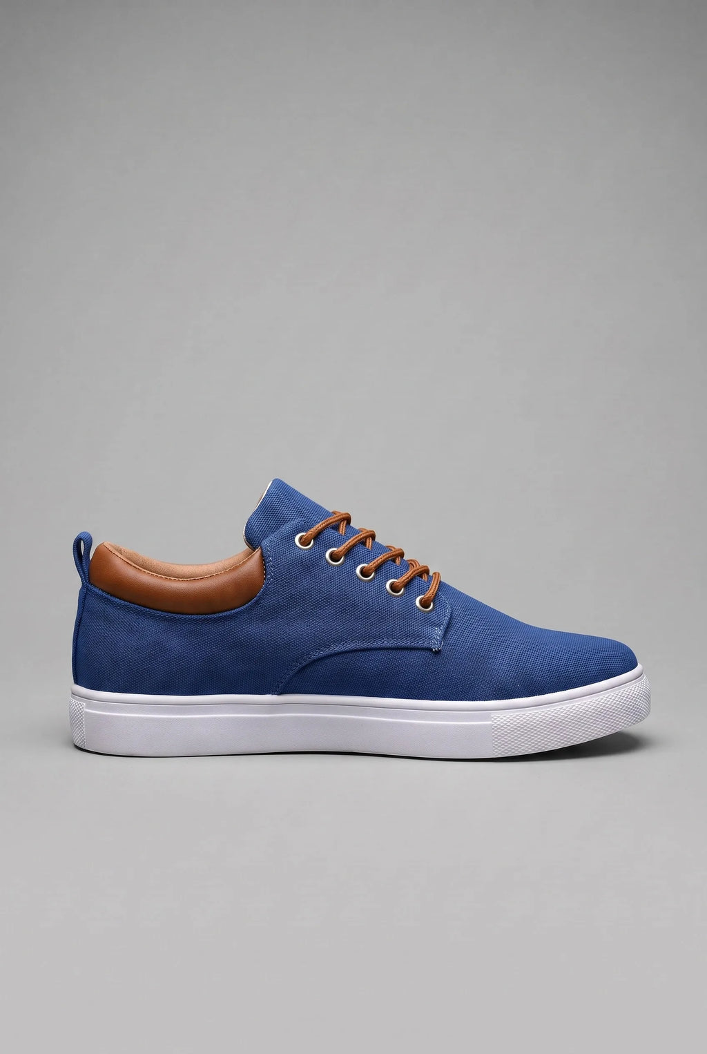 Side profile of navy blue woven trainer with tan leather heel tab and white cupsole