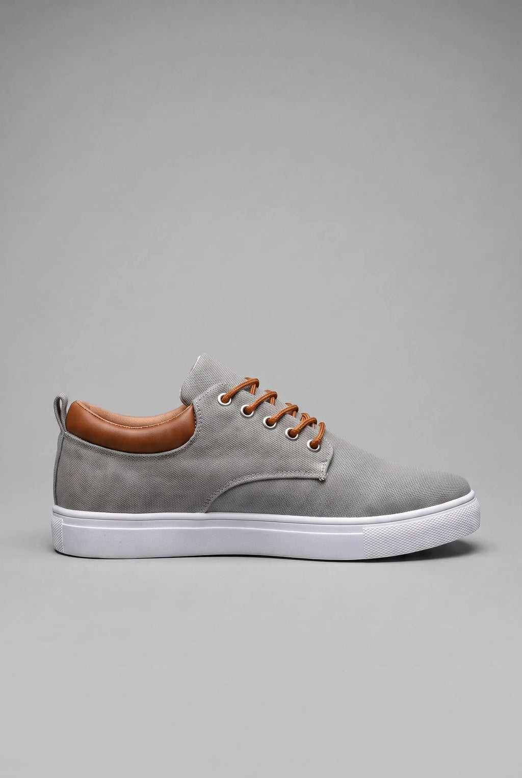 Side profile of grey woven trainer with tan leather heel tab and white cupsole