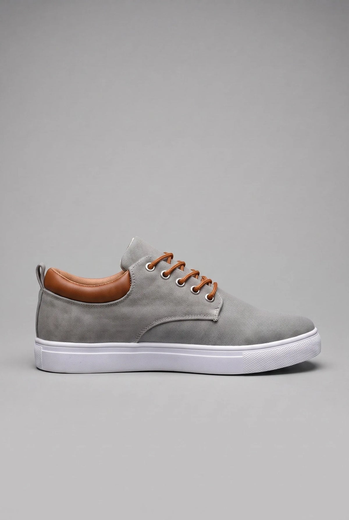 Side profile of grey woven trainer with tan leather heel tab and white cupsole