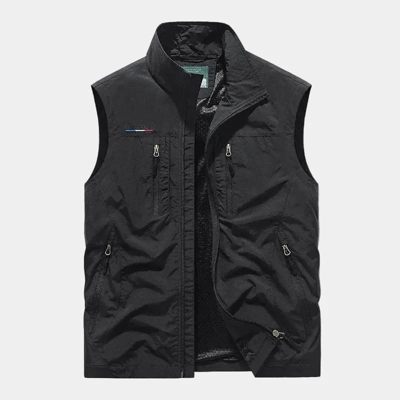 Black sleeveless zip gilet with stand-up collar, front zip pockets and mesh lining visible inside