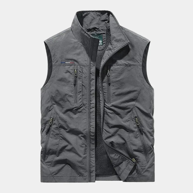Grey zip gilet with stand collar, four zipped pockets and soft mesh inner lining shown open