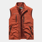 Rust orange zip gilet with contrast black zips, stand collar and zipped pockets, shown front on