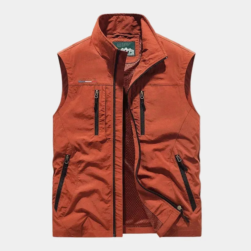 Rust orange zip gilet with contrast black zips, stand collar and zipped pockets, shown front on
