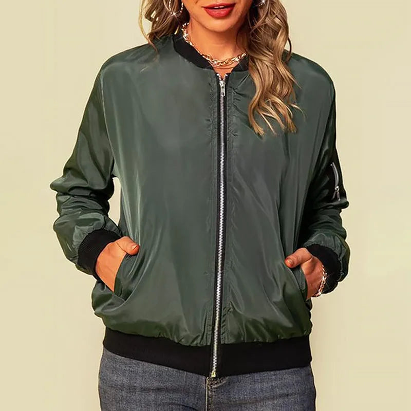 Full front view of a khaki green bomber jacket on a model, hands in pockets, showing hip-length fit and ribbed hem